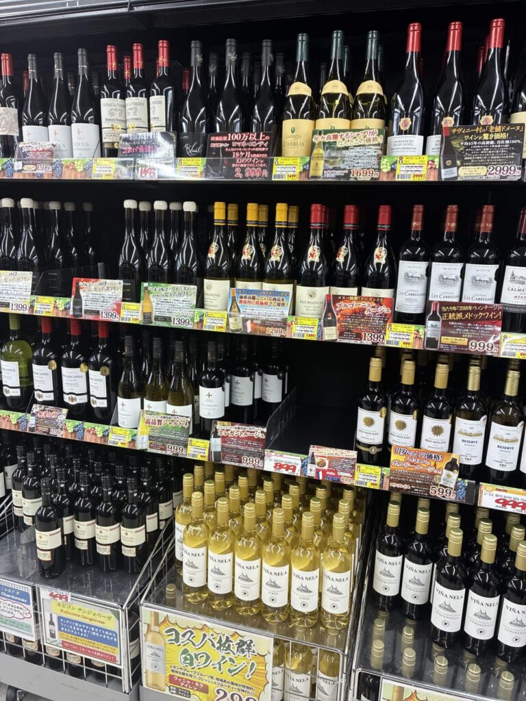 壁面棚にズラリと並ぶボトル。産地ごとに区画され、各銘柄に詳細なPOPカードが付く